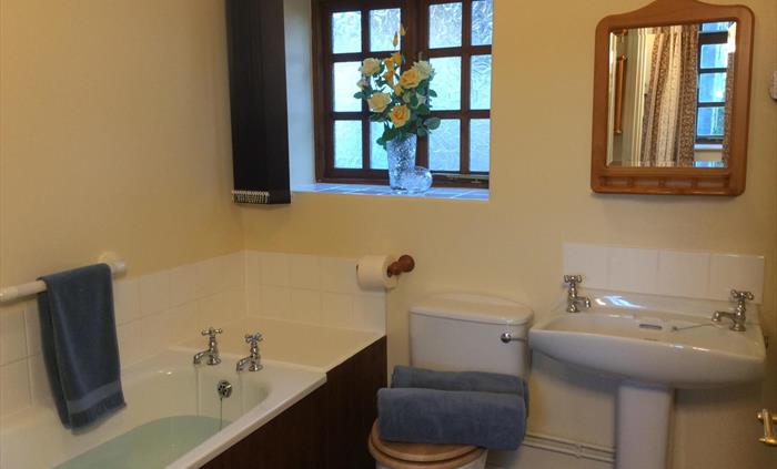 Aberyscir Coach House bathroom with bath and electric over bath shower